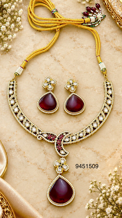 Antique gold kundan necklace and earring set in red
