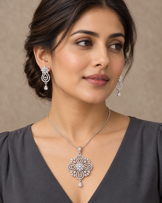 Model wearing the floral teardrop chain pendant and earring set in white