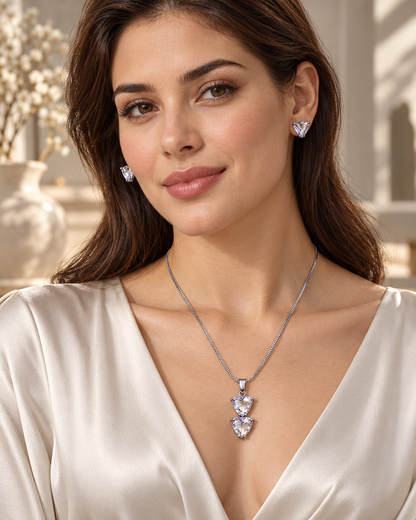 Model wearing twin triangle chain pendant and stud set in White with Silver-tone finish